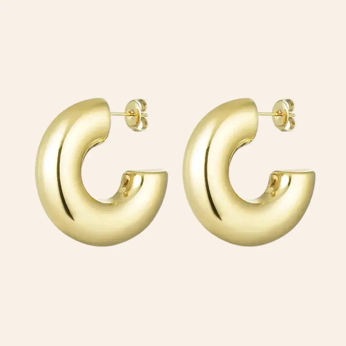 Boucles Vérone en acier inoxydable doré, créoles épaisses au design moderne, présentées seules sur fond neutre.