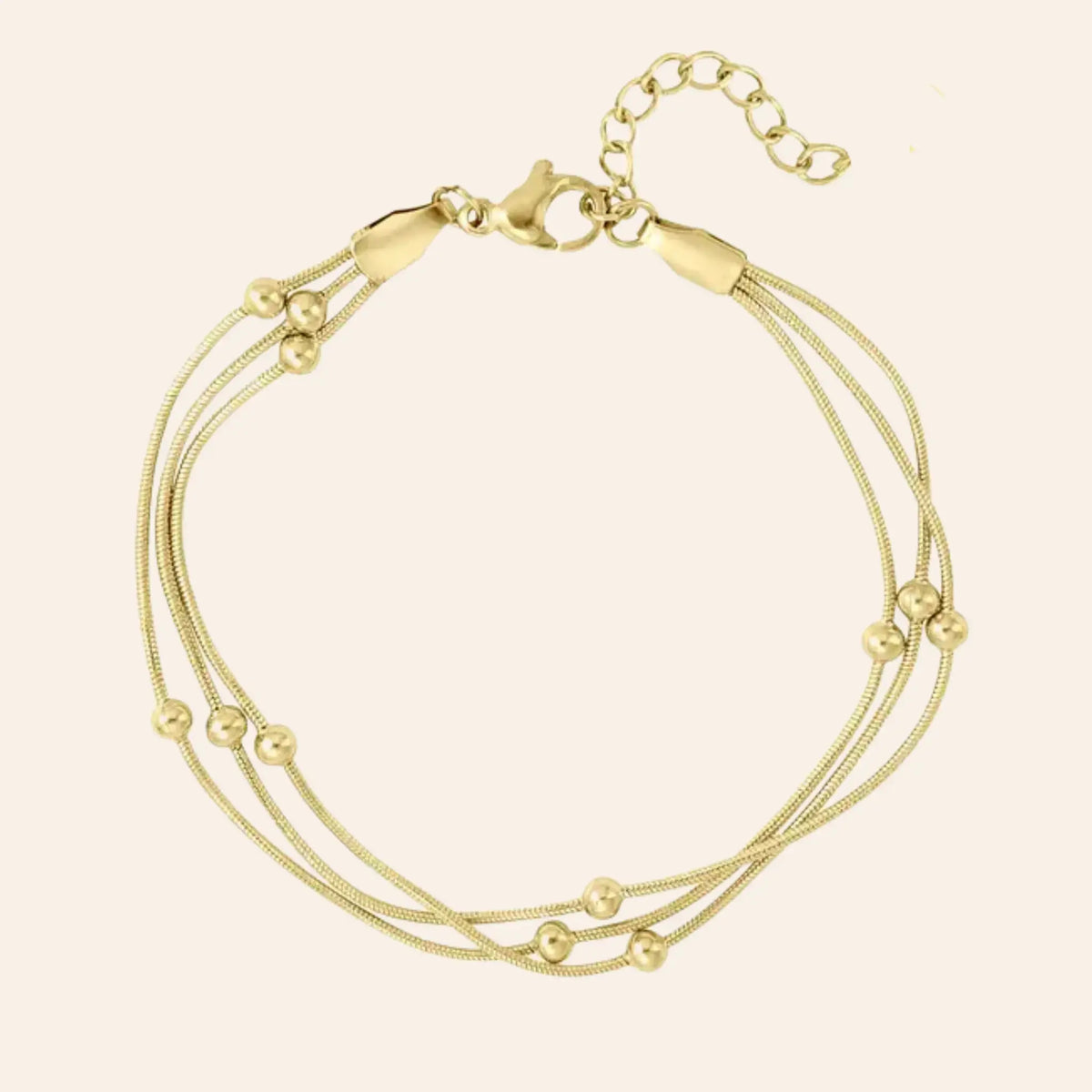 Bracelet Barcelone en acier inoxydable doré, fines chaînes entrelacées avec petites perles délicates, présenté seul sur fond neutre.