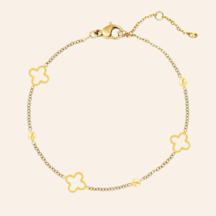 Bracelet Dublin en acier inoxydable doré, design fin avec des trèfles et des boules espacées, présenté seul sur fond neutre.