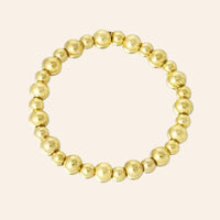 Bracelet Grenade en acier inoxydable doré, composé de perles dorées délicates, présenté seul sur fond neutre.