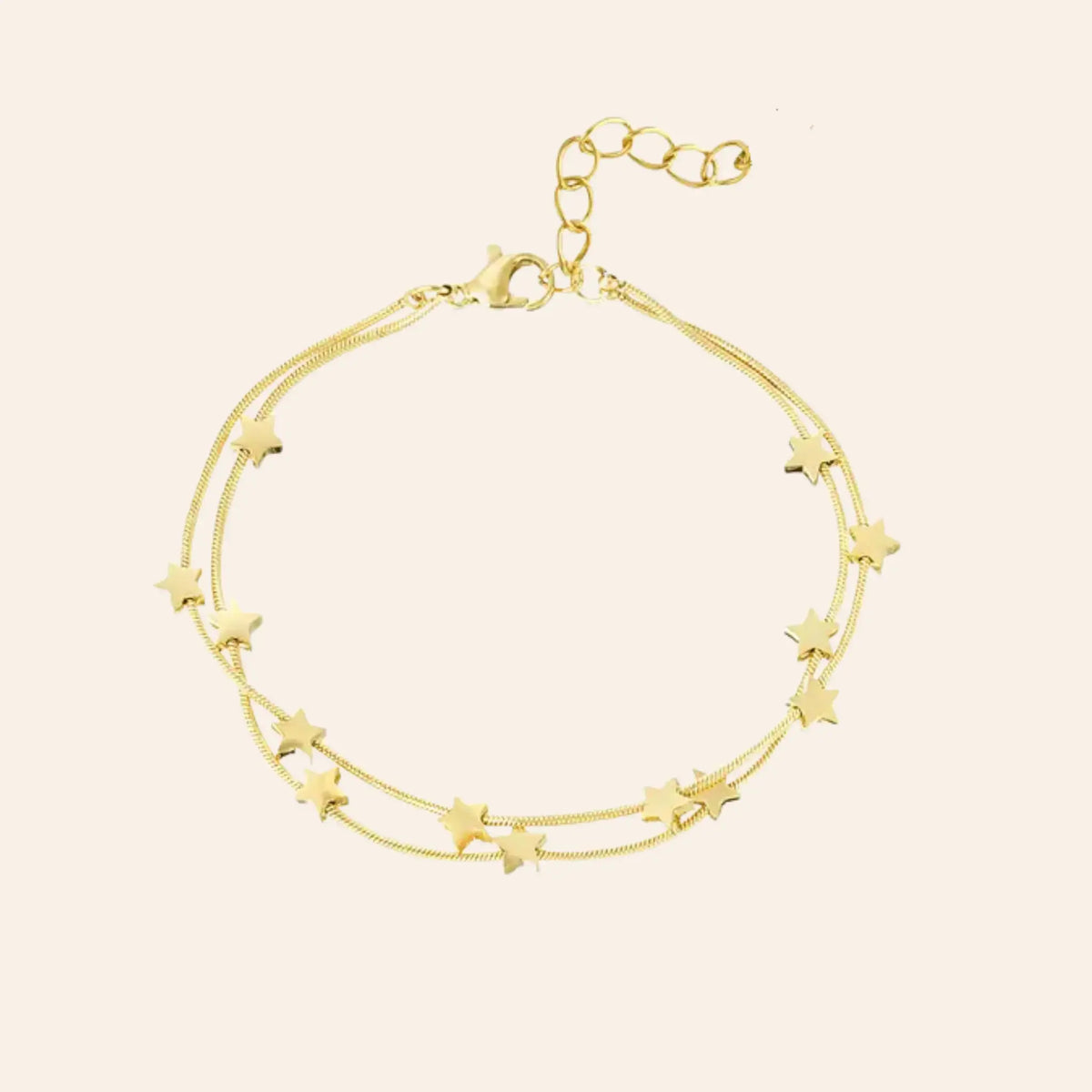 Bracelet Oslo en acier inoxydable doré, double chaîne délicate ornée de petites étoiles, design épuré inspiré par la sérénité nordique, présenté seul sur fond neutre.
