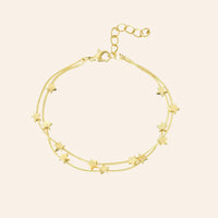 Bracelet Oslo en acier inoxydable doré, double chaîne délicate ornée de petites étoiles, design épuré inspiré par la sérénité nordique, présenté seul sur fond neutre.
