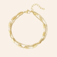 Bracelet Santiago en acier inoxydable doré, chaînes multi-rangs et maillons délicats, design sophistiqué et dynamique, présenté seul sur fond neutre.
