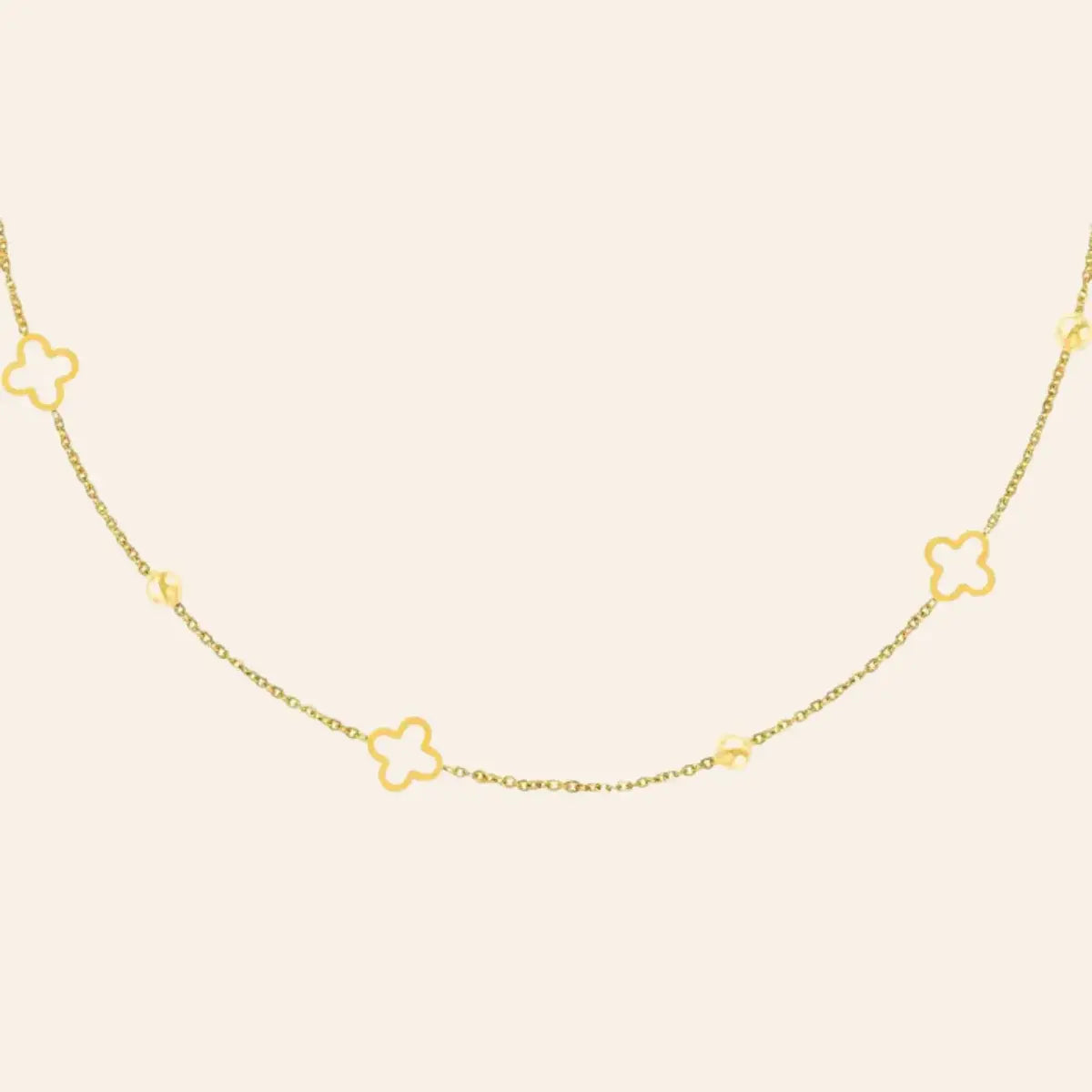 Collier Dublin en acier inoxydable doré, chaîne délicate ornée de trèfles et de boules espacées, présenté seul sur fond neutre.