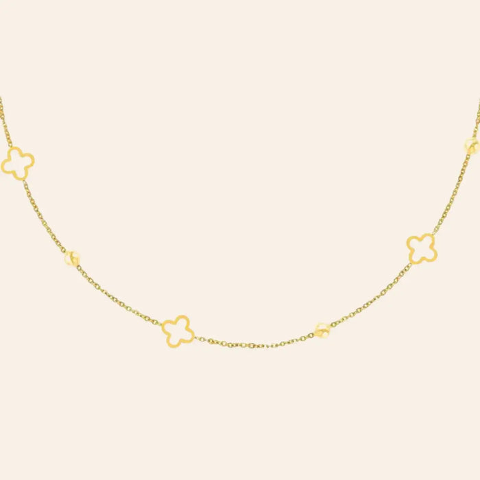 Collier Dublin en acier inoxydable doré, chaîne délicate ornée de trèfles et de boules espacées, présenté seul sur fond neutre.