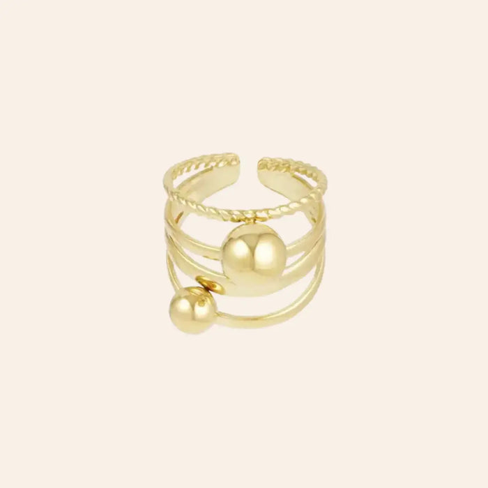 Bague ajustable dorée en acier inoxydable avec billes, design tendance et structuré.