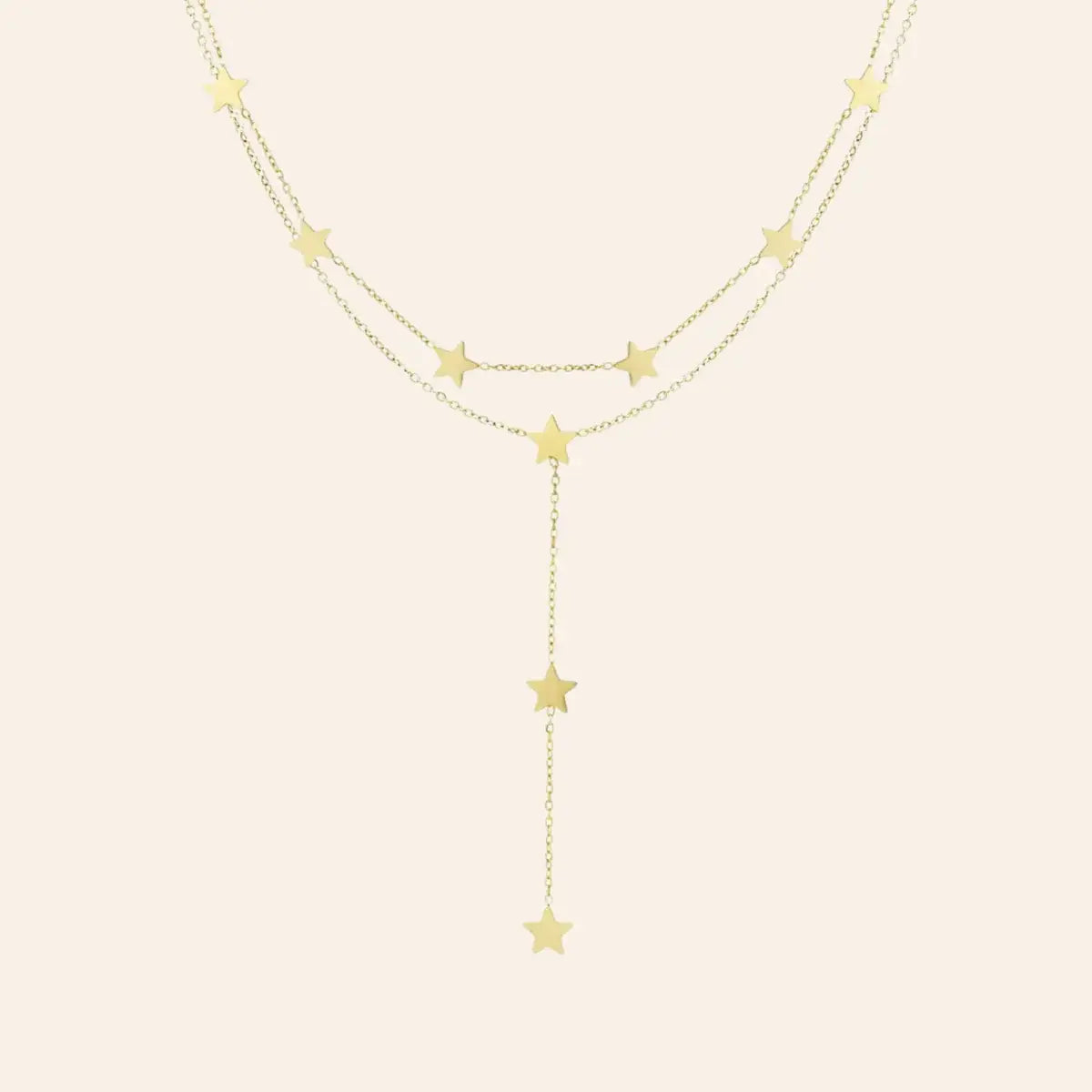 Collier Oslo en acier inoxydable doré, chaîne délicate avec étoiles suspendues en cascade, ajoutant une touche céleste et romantique, présenté seul sur fond neutre.